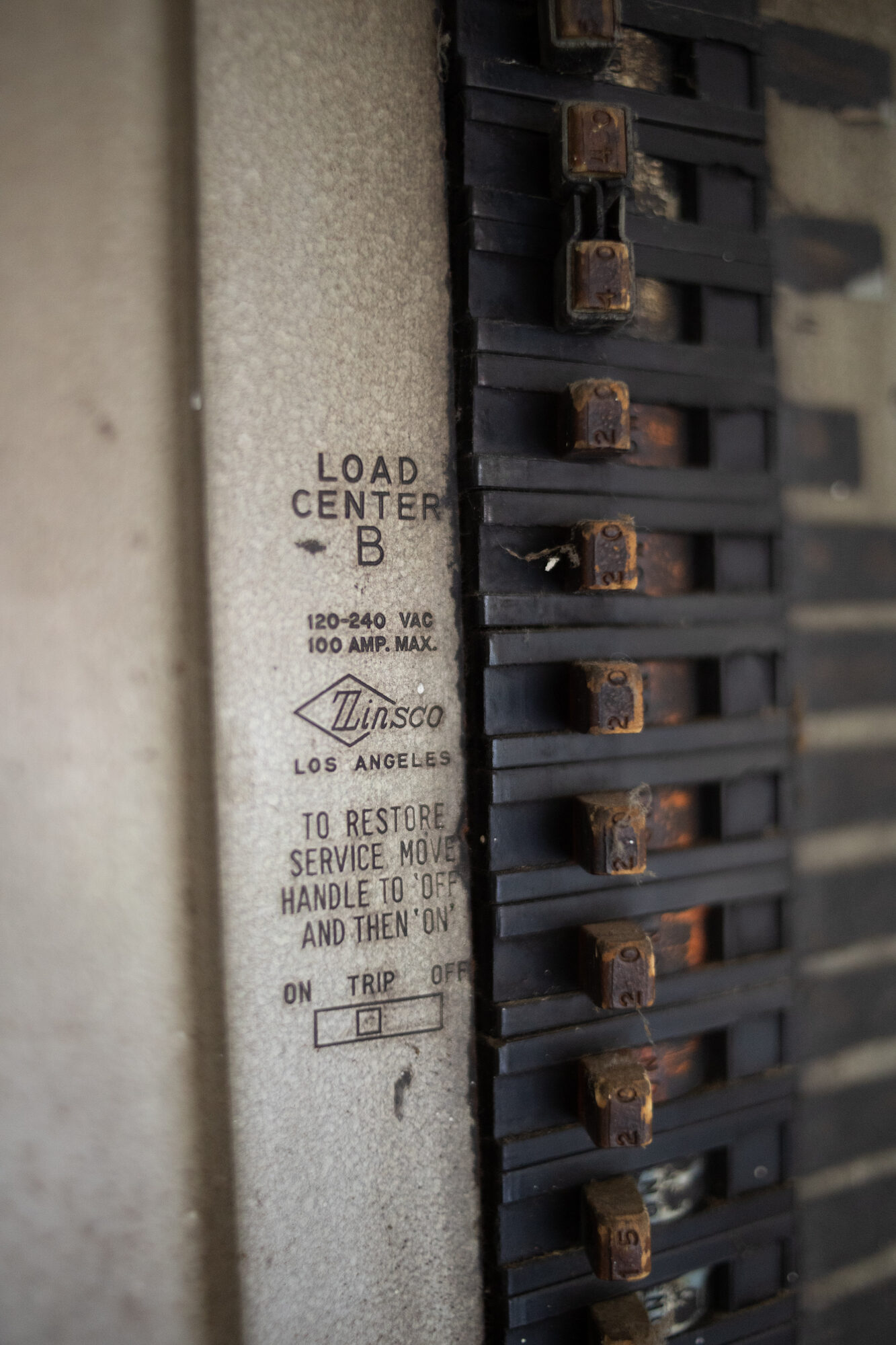 Rusted 100-amp fuse panel in an older Tulsa home, an expensive as-is repair item