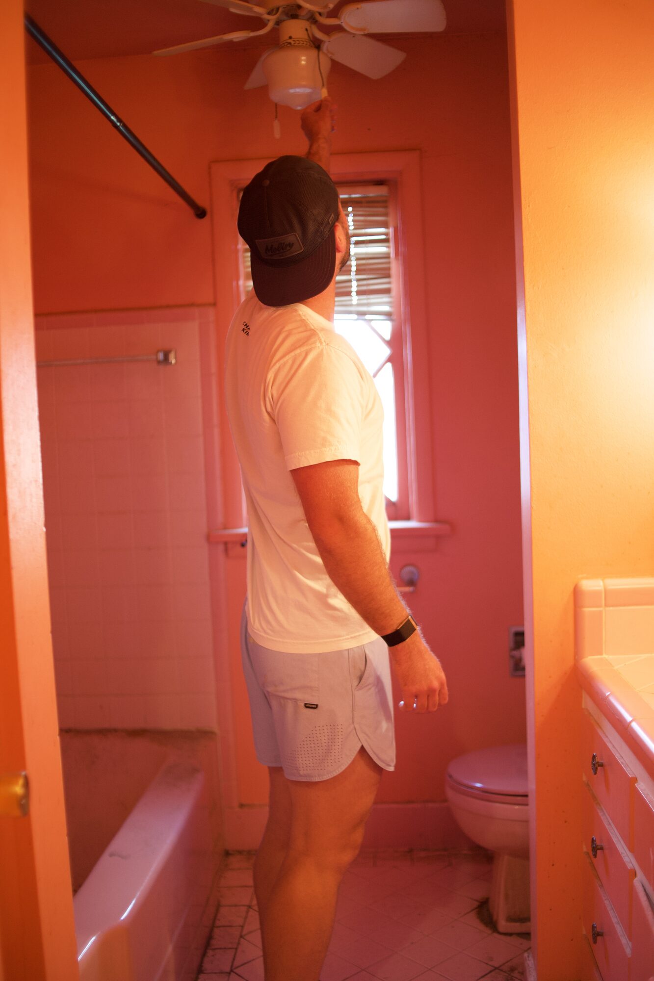 Original pink tile bathroom in an older Tulsa house, the kind of dated finish that drives repair credits at closing